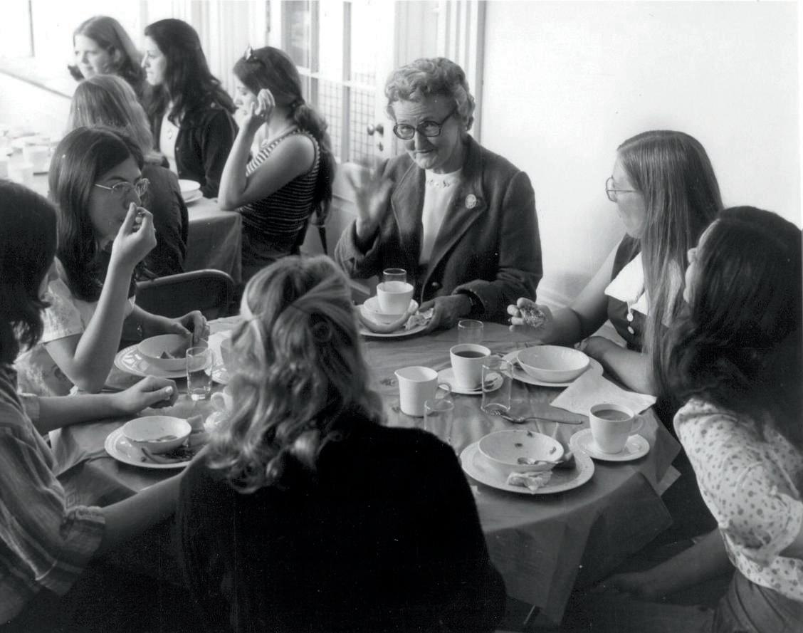 Laura Johnson, third dean and first president at Hartford College for Women at dinner with students.